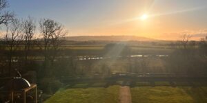 Sunset over the rolling English countryside of the Cotswolds