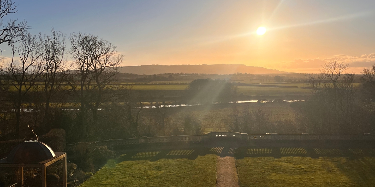 Sunset over the rolling English countryside of the Cotswolds