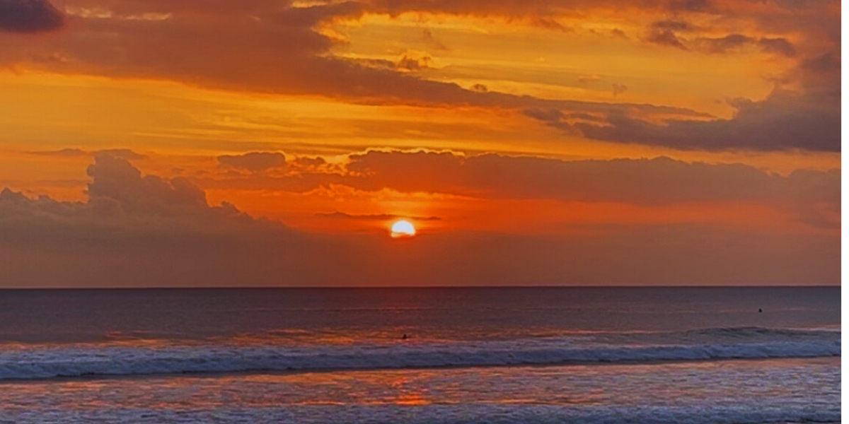 Sunset from Legian Beach the sky turns a rich blend of orange and red