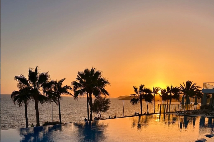 Sunset at Meloneras Gran Canaria from the palm lined promenade 
